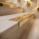 Solid brass stair nosing 62mm ribbed tread in polished brass finish fitted on a step edge