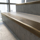 Solid Brass Stair Nosing 62mm Ribbed Tread Ramped Back in antique brass finish fitted on a step edge