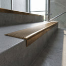 Solid Brass Stair Nosing 62mm Ribbed Tread Ramped Back in antique bronze finish fitted on a step edge