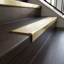 Solid Brass Stair Nosing 62mm Ribbed Tread Ramped Back in satin brass finish fitted on a step edge