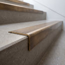 Solid Brass Stair Nosing 62mm Ribbed Tread Ramped Edge in antique bronze finish fitted on a step edge