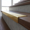 Solid Brass Stair Nosing 62mm Ribbed Tread Ramped Edge in polished brass finish fitted on a step edge