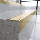 Solid Brass Stair Nosing 62mm Ribbed Tread Ramped Edge in satin brass finish fitted on a step edge