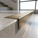 Solid Brass Stair Nosing 62mm Tread Raked Front Profile in antique brass finish fitted on a step edge