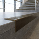 Solid Brass Stair Nosing 62mm Tread Raked Front Profile in antique bronze finish fitted on a step edge