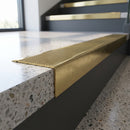 Solid Brass Stair Nosing 62mm Tread Raked Front Profile in polished brass finish fitted on a step edge