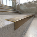 Solid Brass Stair Nosing 67mm Ribbed Tread Raked Front in antique brass finish fitted on a step edge