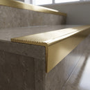 Solid Brass Stair Nosing 67mm Ribbed Tread Raked Front in polished brass finish fitted on a step edge