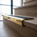 Solid Brass Stair Nosing 69.5mm Tread Bullnose Profile in polished brass finish fitted on a step edge