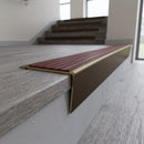 Solid brass stair nosing 71mm raked back in antique bronze with claret castellated insert fitted on an oak domestic hallway staircase