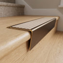 Solid brass stair nosing 71mm raked back in antique bronze with fawn castellated insert fitted on a terrazzo museum foyer staircase