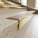 Solid brass stair nosing 71mm raked back in polished brass with fawn castellated insert fitted on a terrazzo museum foyer staircase