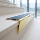 Solid brass stair nosing 71mm raked back in polished brass with regency castellated insert fitted on a limestone office staircase