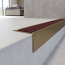 Solid Brass Stair Nosing 71mm Tread Square Front Slimline in Antique Brass finish with Claret Castellated insert fitted on a modern office reception staircase with porcelain tile treads