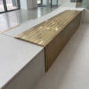 Solid Brass Stair Nosing 71mm Tread Square Front Slimline in Antique Brass finish with Polished Brass insert fitted on a modern office reception staircase with porcelain tile treads
