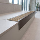 Solid Brass Stair Nosing 71mm Tread Square Front Slimline in Antique Bronze finish with Antique Brass insert fitted on a modern office reception staircase with porcelain tile treads