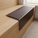Solid Brass Stair Nosing 71mm Tread Square Front Slimline in Antique Bronze finish with Peat Castellated insert fitted on a residential oak staircase