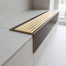 Solid Brass Stair Nosing 71mm Tread Square Front Slimline in Antique Bronze finish with Polished Brass insert fitted on a modern office reception staircase with porcelain tile treads