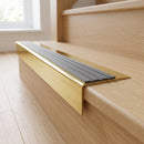 Solid Brass Stair Nosing 71mm Tread Square Front Slimline in Polished Brass finish with Flint Castellated insert fitted on a residential oak staircase