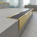 Solid Brass Stair Nosing 71mm Tread Square Front Slimline in Polished Brass finish with Nimbus Castellated insert fitted on a modern office reception staircase with porcelain tile treads