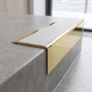 Solid Brass Stair Nosing 71mm Tread Square Front Slimline in Polished Brass finish with Polar Grey Smooth Textured insert fitted on a retail store staircase with polished concrete treads