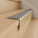 Solid Brass Stair Nosing 71mm Tread Square Front Slimline in Satin Brass finish with Flint Castellated insert fitted on a residential oak staircase
