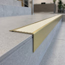 Solid Brass Stair Nosing 71mm Tread Square Front Slimline in Satin Brass finish with Ivory Castellated insert fitted on a modern office reception staircase with porcelain tile treads