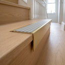 Solid Brass Stair Nosing 71mm Tread Square Front Slimline in Satin Brass finish with Light Grey Castellated insert fitted on a residential oak staircase