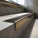 Solid Brass Stair Nosing 71mm Tread Raked Back Profile in antique brass finish fitted on a step edge