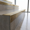 Solid Brass Stair Nosing 71mm Tread Raked Back Single Channel in antique brass finish fitted on a step edge