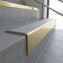 Solid Brass Stair Nosing 71mm Tread Raked Back Single Channel in satin brass finish fitted on a step edge