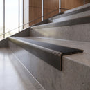 Antique Bronze finish - solid brass stair nosing with black anti-slip insert fitted on concrete steps