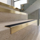 Satin Brushed finish - solid brass stair nosing with black carborundum insert fitted on travertine steps