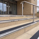 Mirror polished silver 56mm square aluminium stair nosing with coal (black) exterior grip insert on buff concrete entrance steps outside a health centre