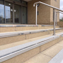 Mirror polished silver 56mm square aluminium stair nosing with everest (light grey) exterior grip insert on buff concrete entrance steps outside a health centre