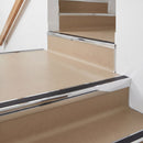 Square aluminium stair nosing with black insert in bright polished finish fitted on a shop entrance stair with beige lino