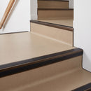 Square aluminium stair nosing with black insert in dark bronze finish fitted on a shop entrance stair with beige lino