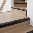 Square aluminium stair nosing with black insert in satin black finish fitted on a shop entrance stair with beige lino