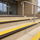 Dark bronze 56mm square aluminium stair nosing with brimstone (safety yellow) exterior grip insert on buff concrete entrance steps outside a health centre