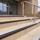 Dark bronze 56mm square aluminium stair nosing with everest (light grey) exterior grip insert on buff concrete entrance steps outside a health centre