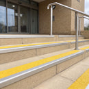 Mill finish 56mm square aluminium stair nosing with brimstone (safety yellow) exterior grip insert on buff concrete entrance steps outside a health centre