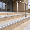 Mill finish 56mm square aluminium stair nosing with everest (light grey) exterior grip insert on buff concrete entrance steps outside a health centre
