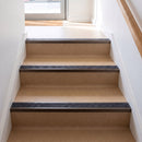 Square edge aluminium stair nosing with a dark charcoal Mor Grip insert in dark bronze finish fitted on a shop or office entrance stair finished in beige lino