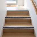 Square edge aluminium stair nosing with a dark charcoal Mor Grip insert in mill finish finish fitted on a shop or office entrance stair finished in beige lino