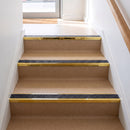 Square edge aluminium stair nosing with a dark charcoal Mor Grip insert in mirrorflect gold finish fitted on a shop or office entrance stair finished in beige lino