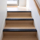 Square edge aluminium stair nosing with a dark charcoal Mor Grip insert in satin black finish fitted on a shop or office entrance stair finished in beige lino