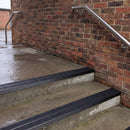 Square edge aluminium stair nosing with black gritted exterior grip insert in satin black finish fitted on covered external concrete steps