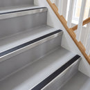 Square aluminium stair nosing with black insert in mill finish fitted on a home staircase with grey vinyl