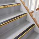 Square aluminium stair nosing with black insert in mirrorflect gold finish fitted on a home staircase with grey vinyl
