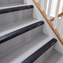 Square aluminium stair nosing with black insert in satin black finish fitted on a home staircase with grey vinyl